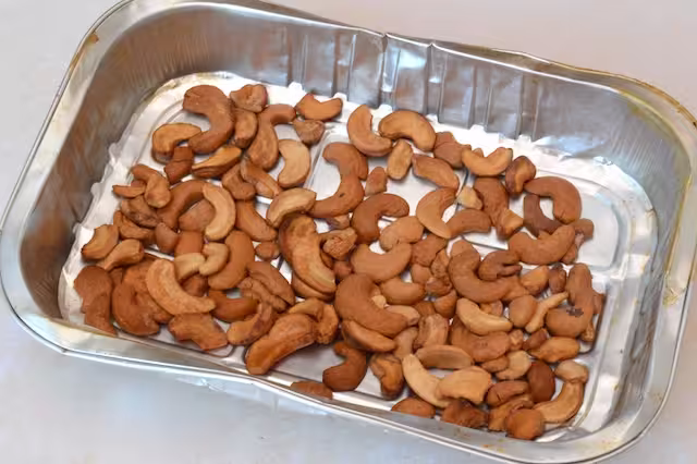 Roasted cashew nuts in tray.