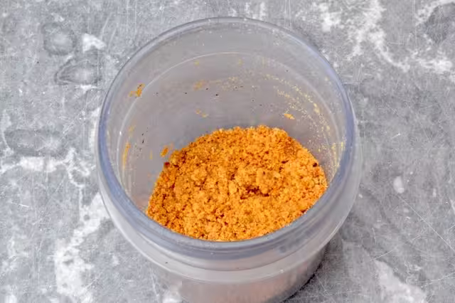 Roasted hazelnuts ground into crumbs.
