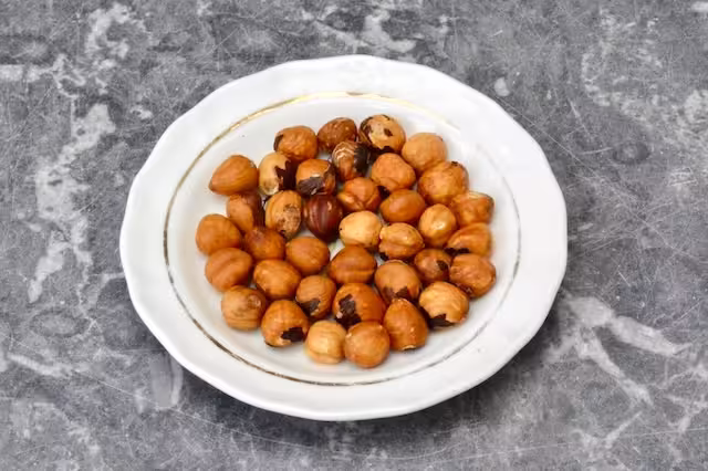 Small plated with skinned roasted hazelnuts.