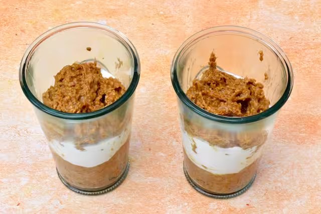 Two glasses with third layer of breakfast tiramisu added.