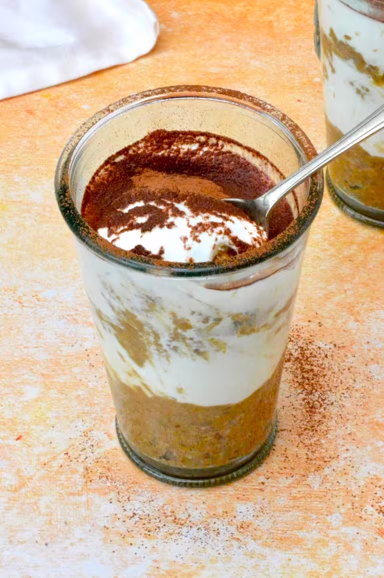 Breakfast tiramisu pots with spoon inserted into main one.