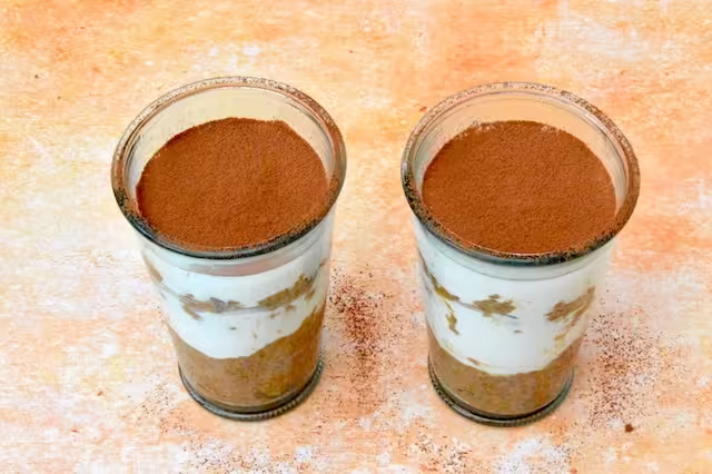 Tiramisu breakfast pots dusted with cocoa powder.