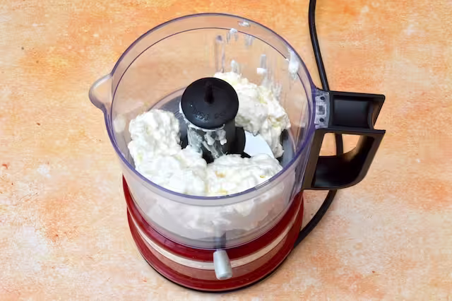 Cottage cheese and vanilla extract in mini blender.