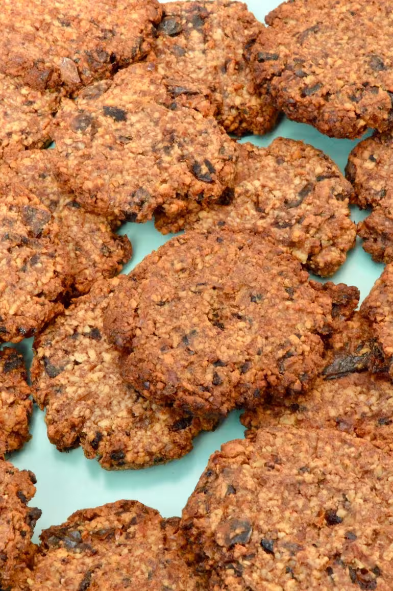 Close up of a plate of 2-ingredient date and almond cookies.