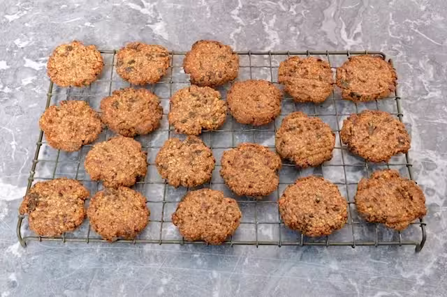 Date and almond cookies on cooling rack.