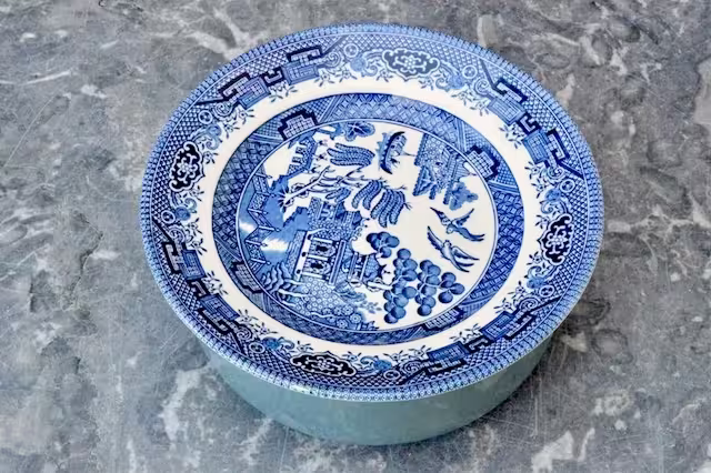 Bowl of soaking dates covered with plate.