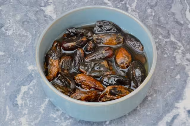 Dates soaking in bowl of water.