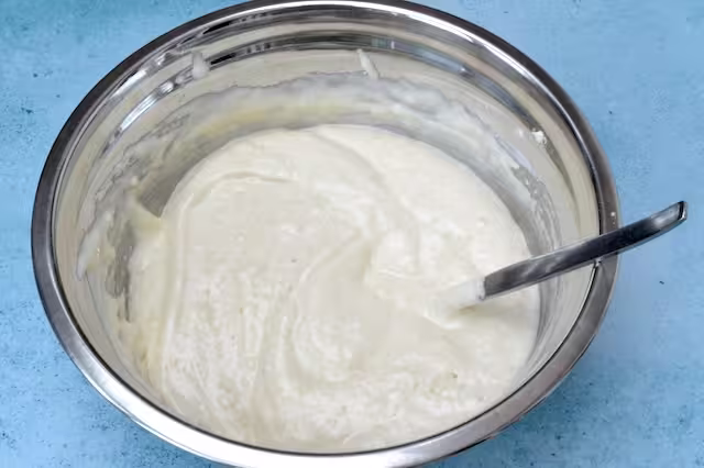 Flour incorporated into bowl of whisked egg mixture.