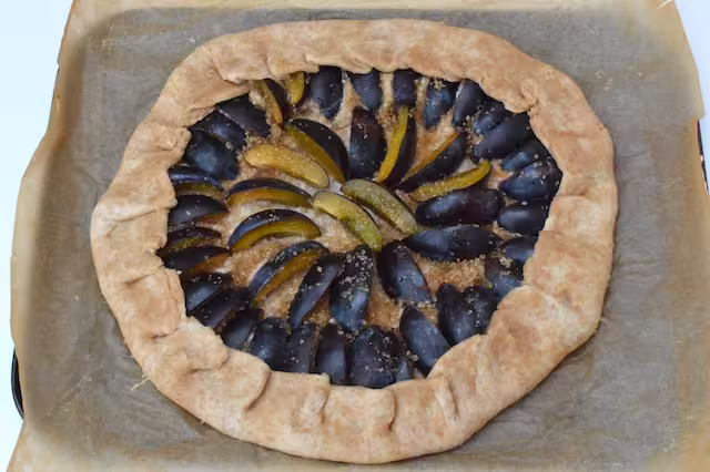 Pastry turned inwards to cover outer edges of plum filling.