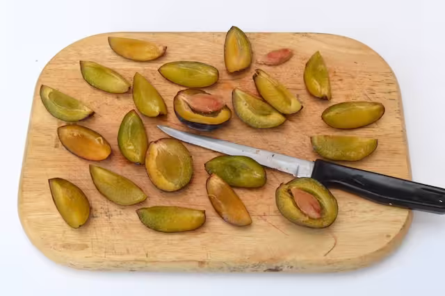Plums with stones removed and cut into halves and quarters.