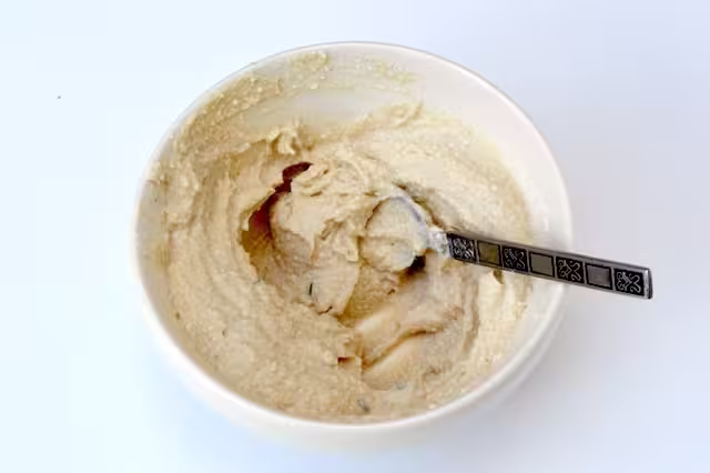 Ricotta filling in bowl with teaspoon.