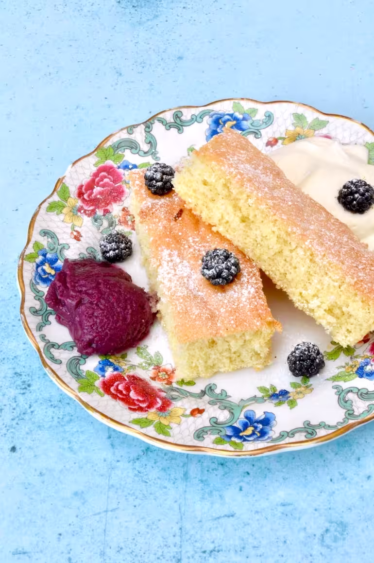 Deconstructed blackberry trifle on a plate.