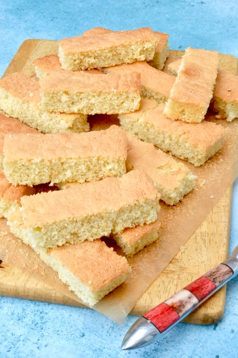 Board piled with freshly baked homemade trifle sponges.