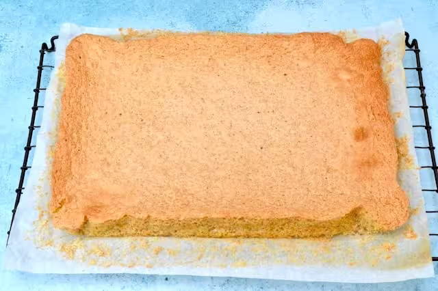 Genoise made with wholemeal spelt on cooling rack.