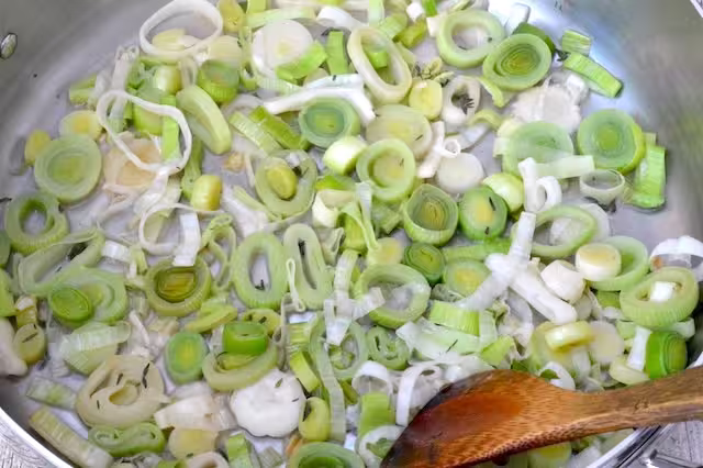 Cider added to leeks in pan and reduced.