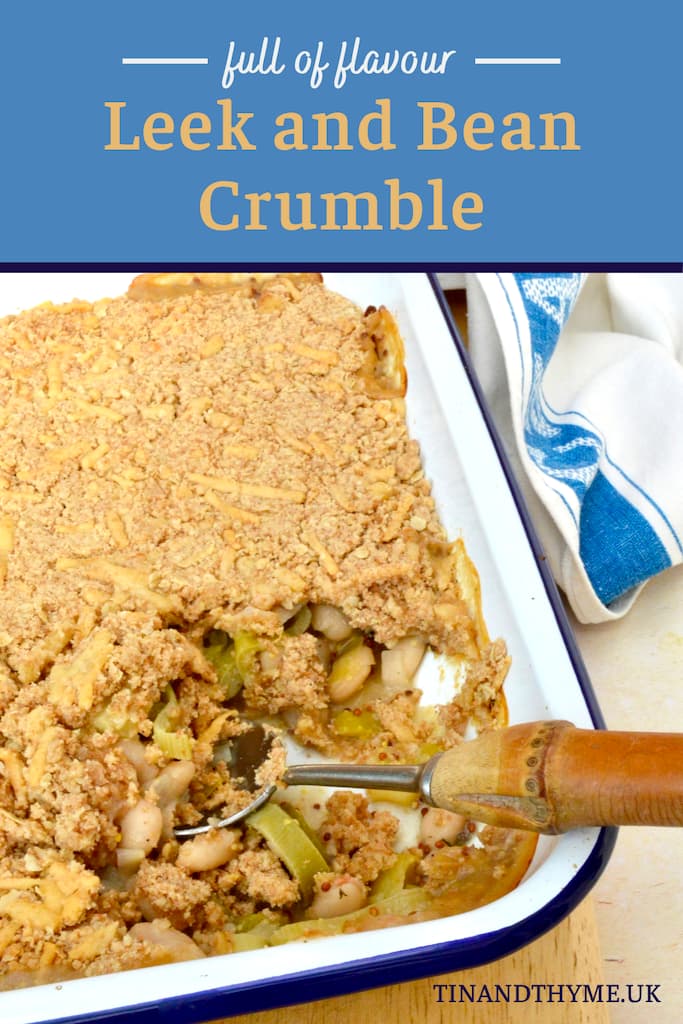Leek and bean crumble with portion removed and spoon inserted.