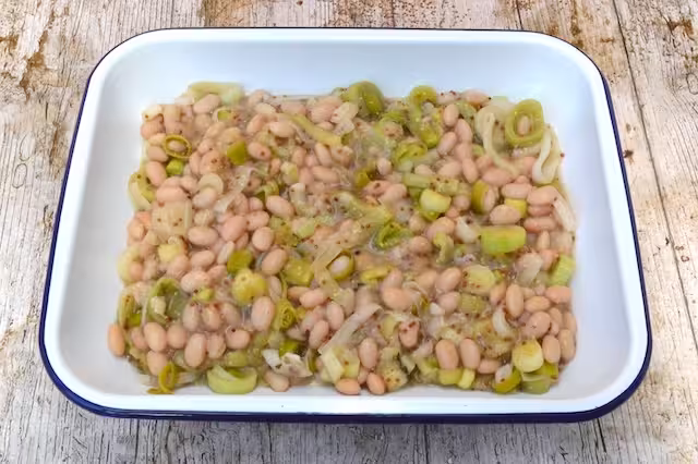 Leeks and beans in baking dish.