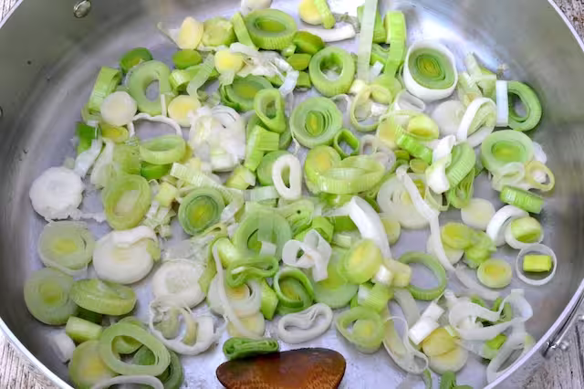 Leeks frying gently in pan.