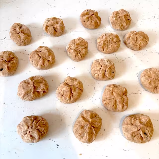 Pastry circles folded over filling to form little dumplings.