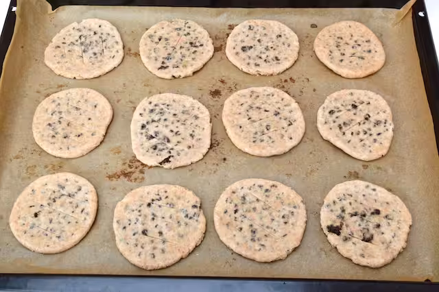 Raw Chorley cakes on baking tray.